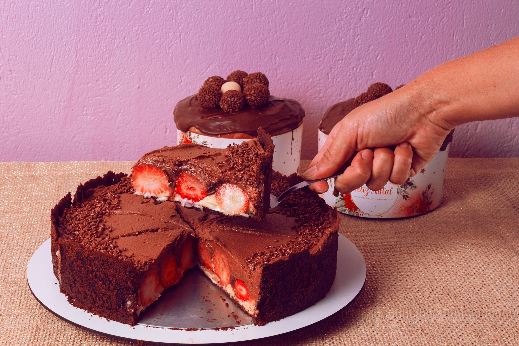 a-person-cutting-a-piece-of-chocolate-cake.jpg a person cutting a piece of chocolate cake